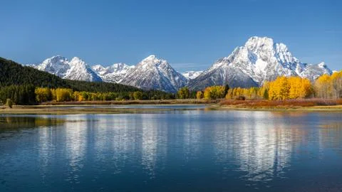 Reflection of snowcapped Mount Moran over Snake River. Stock Photos