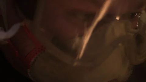 A reflection of sparks on the protective mask Stock Footage 129045121