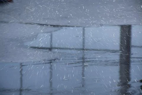 Reflection of the spring sky in a puddle in March Stock Photos