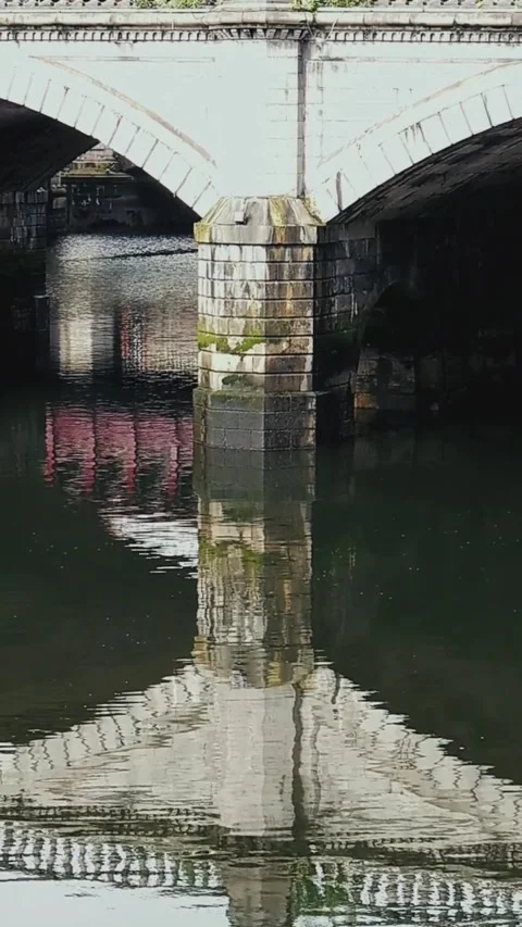 Reflection of stone bridge on river surface - Vertical Video Stock Footage 200401052