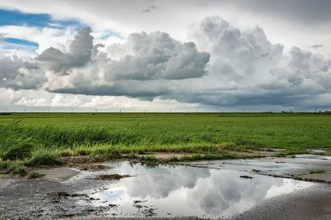 Reflection of storm clouds in a water pool Stock Photos