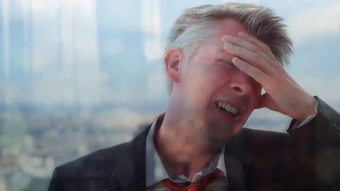 Reflection of a stressed businessman in front of an office window Video stock 80709411