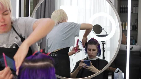 Reflection of stylist and client in mirror. Stock Footage 277799934