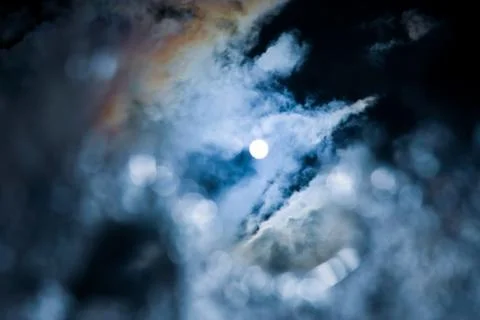 The reflection of the sun and clouds in a puddle of water Stock Photos