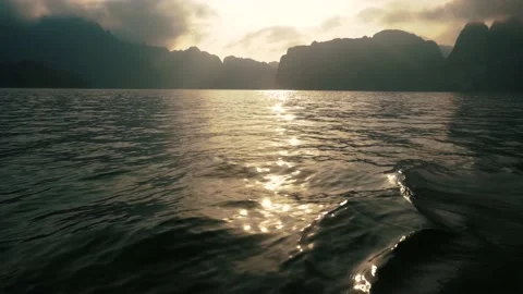 Reflection Sun Light into Ripple Water Toss Boat Floating with View Mountain Stock Footage 154016946