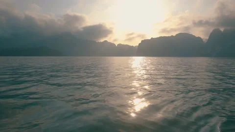 Reflection Sun Light into Water Toss Boat Floating with View Mountain Stock Footage 154016929