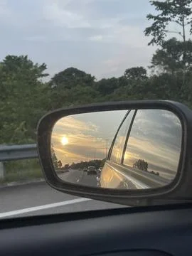 Reflection of the sun in the mirror of a car Stock Photos