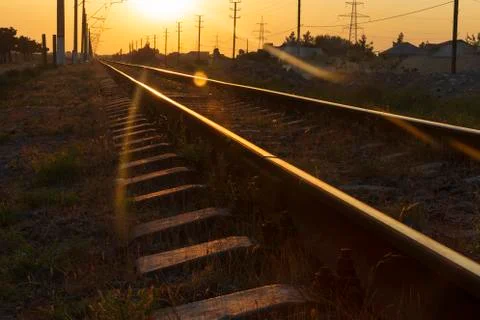 Reflection of the sun on the rails at sunset Stock Photos