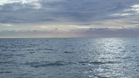 The reflection of the sun on the sea surface and the stony shore Stock Footage 81556667