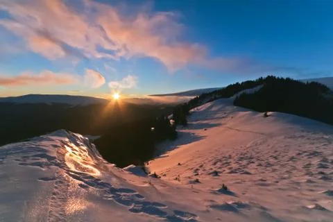 Reflection of sun on snow at sunset Stock Photos