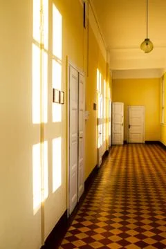 Reflection of the sun on the wall. Corridor in the old building. Stock Photos