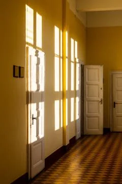 Reflection of the sun on the wall. Corridor in the old building. Stock Photos