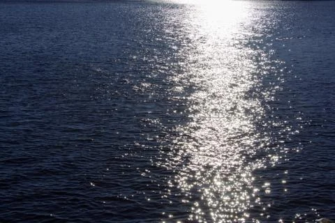 Reflection of the sun on the water Stock Photos