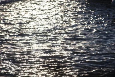 Reflection of sun on water Stock Photos