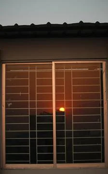 Reflection of the sun on the window glass Stock Photos