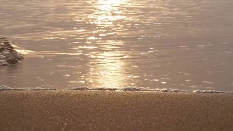Reflection of sunlight golden time sea water waves on sandy shore. sparkling Stock-Footage 166927202