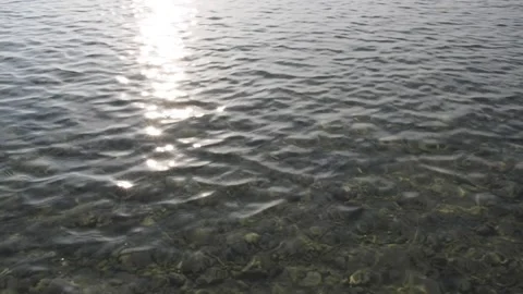 Reflection of sunlight over lake surface in slow motion shiny reflections of Stock Footage 166927164