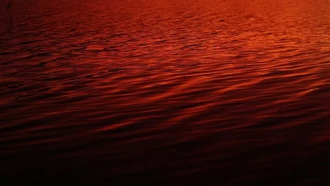 Reflection of sunlight over lake surface sunrise and orange color Stock Footage 242713674