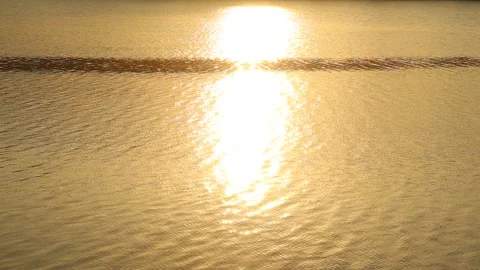 Reflection of sunlight over lake surface sunrise water and orange color Stock Footage 250524635