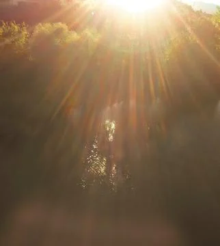 Reflection of sunlight rays in the river water Stock Photos