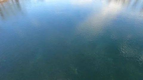 Reflection of sunlight sky white clouds on the water surface. Stock Footage 167765823