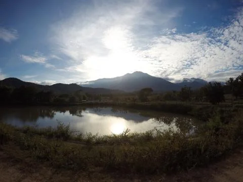 The reflection of the sunset behind the water surface Stock Photos