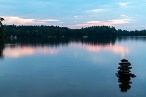 The reflection of sunset in a calm lake Stock Photos
