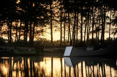 The reflection of the sunset on the fish pond Stock Photos