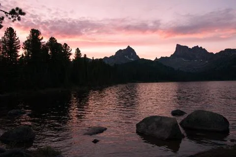 Reflection of sunset in a lake in the mountains Stock Photos