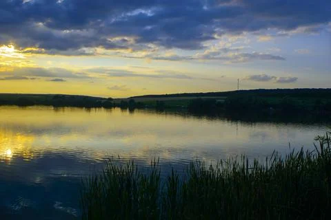 Reflection of the sunset in the lake. Stock Photos