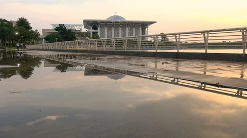 Reflection of Sunset In Puddle In Front Sultan Mizan Zainal Abidin Mosque 스톡 동영상 106947708
