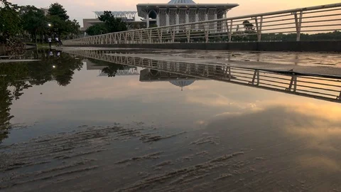 Reflection of Sunset In Puddle In Front Sultan Mizan Zainal Abidin Mosque Video stock 106947713