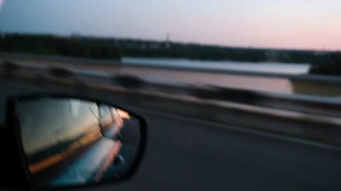 Reflection of the sunset in the rearview mirror of a car. Travel by car. Car Vídeo Stock 211109905