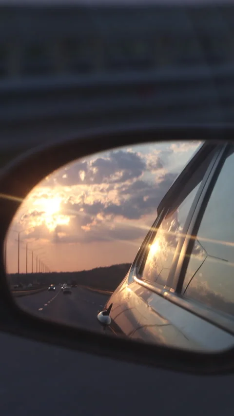 Reflection Of The Sunset In The Rearview Mirror Of The Car. Vertical. Stock Footage 266456918