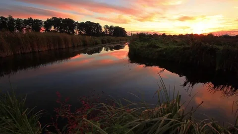 Reflection of the sunset in a small lake Stock Footage 72305456