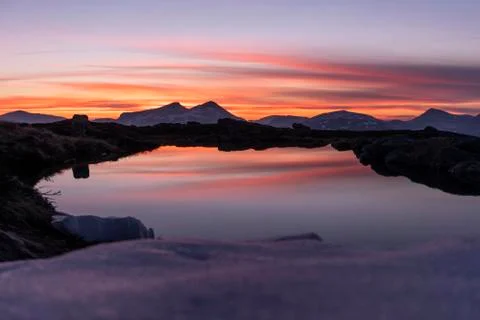 Reflection of a sunset on a small water Stock Photos