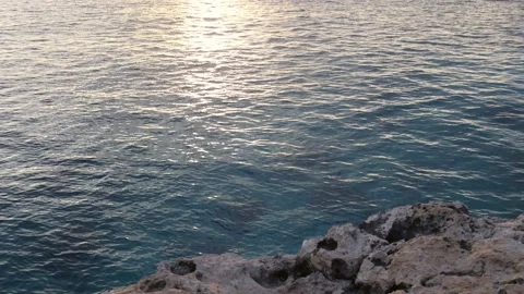 Reflection of the sunset on the surface of blue wavy sea. Stock Footage 168631889