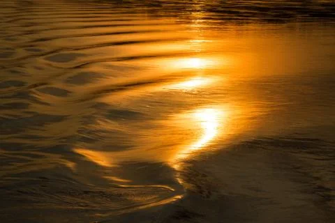 Reflection of the sunset on the watery surface. Stock Photos