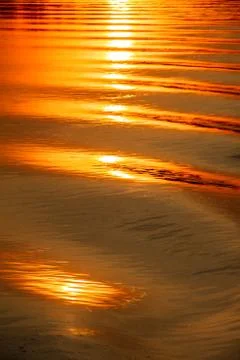 Reflection of the sunset on the watery surface. Stock Photos