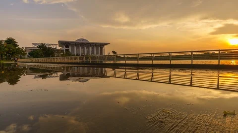 Reflection of sunset on wet sidewalk with Sultan Mizan Mosque Time lapse Stock Footage 96133601