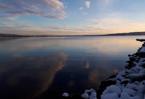 Reflection of the sunset in the winter sea Stock Photos