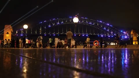Reflection of Sydney Harbour Bridge and night crowds 6K Video stock 330457491