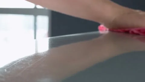 In the reflection of the table surface, one can see the hand and part of the Stock Footage 148899051