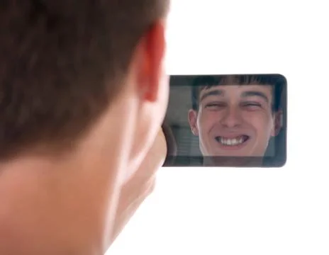 Reflection in Tablet Computer Reflection of Young Man Face in Display of T... Stock Photos