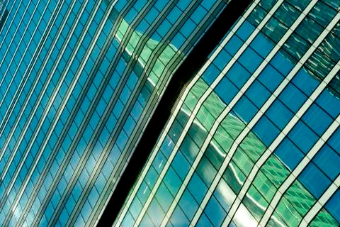 Reflection of a tower of a skyscraper in a glass building of another skyscrap Stockfoto's
