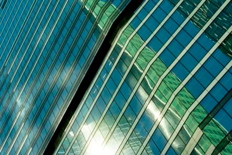 Reflection of a tower of a skyscraper in a glass building of another skyscrap Foto stock