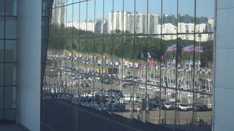 Reflection of traffic and parking lot in the glass of a modern building Stock Footage 111011732
