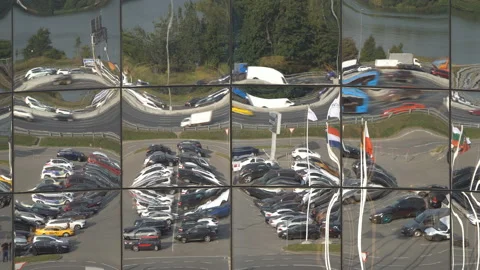Reflection of traffic and parking lot in the glass of a modern building Stock Footage 115501084