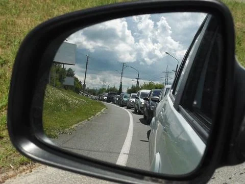 Reflection of a traffic jam in the side view mirror of the car Stock Photos