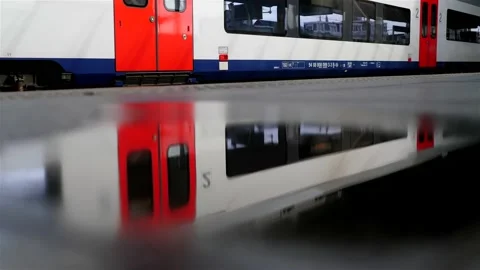 Reflection of train arriving on platform floor during rainy day Stock-Footage 219775081